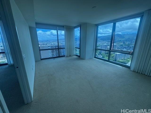 1200 Queen Emma St Unit 3511, Honolulu, HI 96813 - carpeted empty room featuring expansive windows, plenty of natural light, and a mountain view