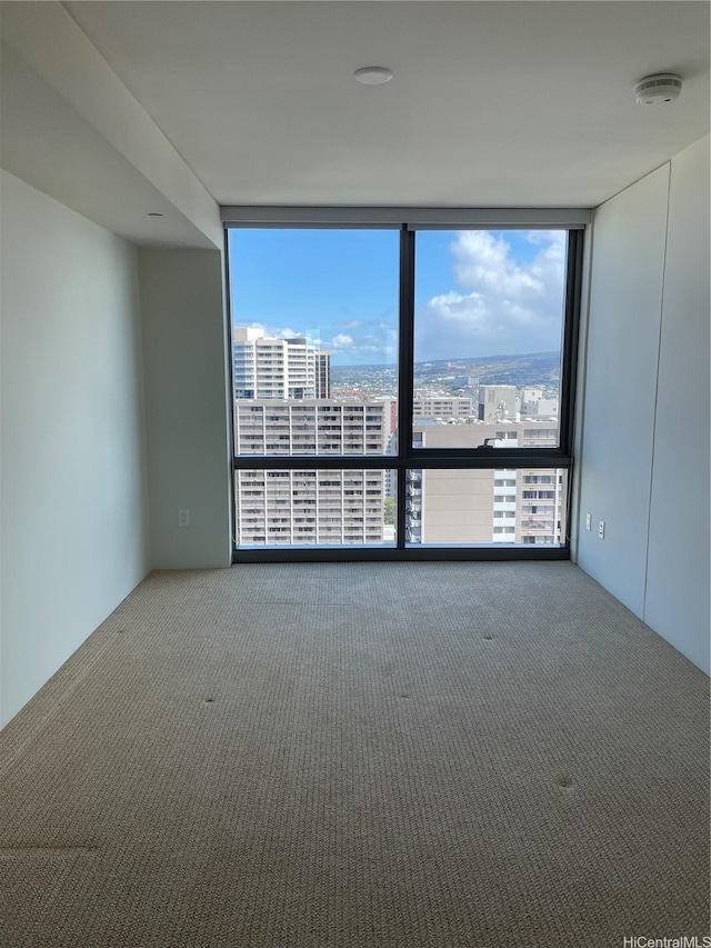 1200 Queen Emma St Unit 3511, Honolulu, HI 96813 - unfurnished room featuring floor to ceiling windows, a smoke detector, carpet floors, and a city view