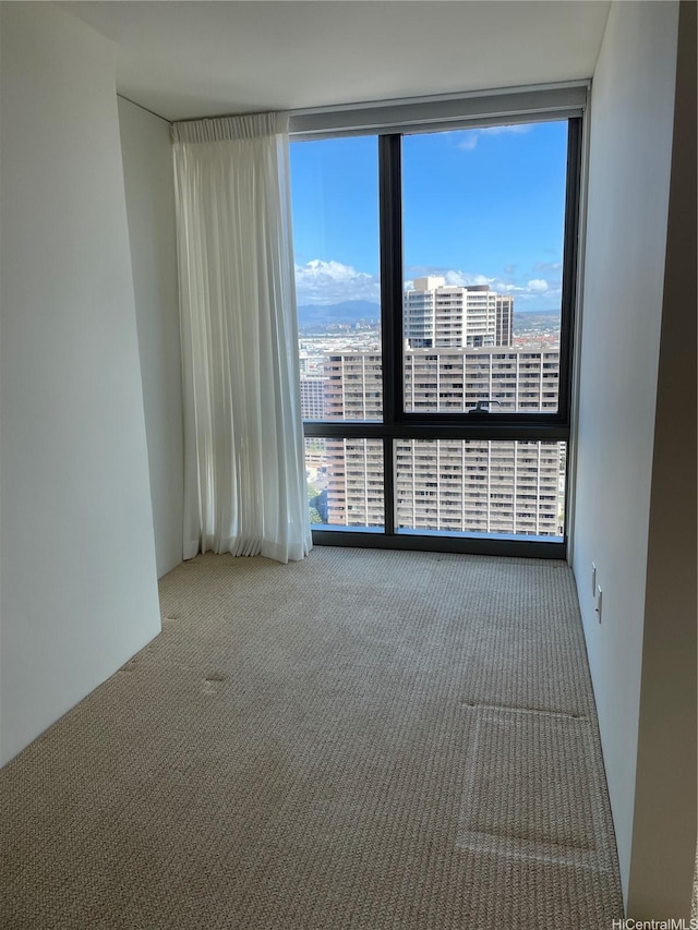 1200 Queen Emma St Unit 3511, Honolulu, HI 96813 - carpeted spare room featuring a wall of windows and a city view