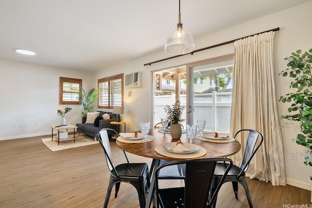 95-983 Ukuwai St Unit 2901, Mililani, HI 96789 - dining area featuring a wall mounted air conditioner, healthy amount of natural light, and wood finished floors