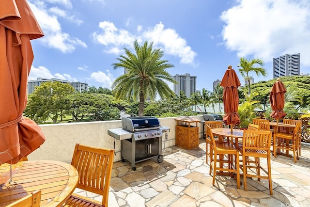 2045 Kalakaua Ave Unit 114, Honolulu, HI 96815 - view of patio / terrace featuring a grill and outdoor dining space