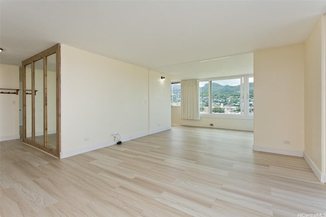 1025 Wilder Ave Unit 12B, Honolulu, HI 96822 - spare room featuring light wood-style flooring and baseboards