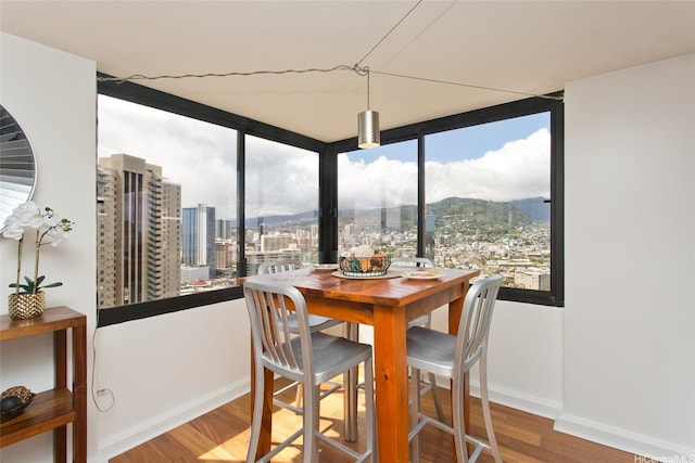 343 Hobron Ln Unit 3401, Honolulu, HI 96815 - dining area featuring wood finished floors and a view of city