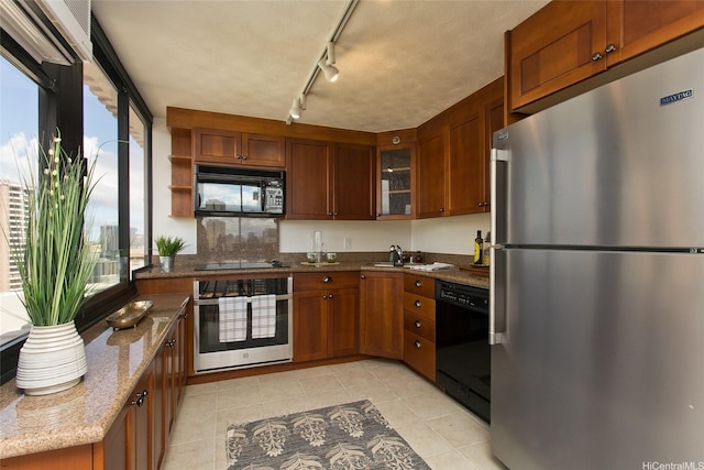343 Hobron Ln Unit 3401, Honolulu, HI 96815 - kitchen featuring black appliances, healthy amount of natural light, dark stone counters, and brown cabinets