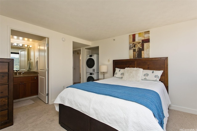 343 Hobron Ln Unit 3401, Honolulu, HI 96815 - bedroom with stacked washer and clothes dryer, light carpet, and connected bathroom