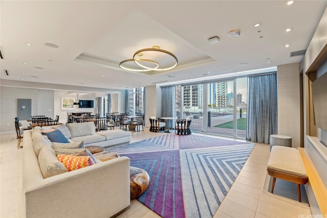 629 Keeaumoku St Unit 2408, Honolulu, HI 96814 - living area featuring a raised ceiling, light tile patterned flooring, expansive windows, and recessed lighting