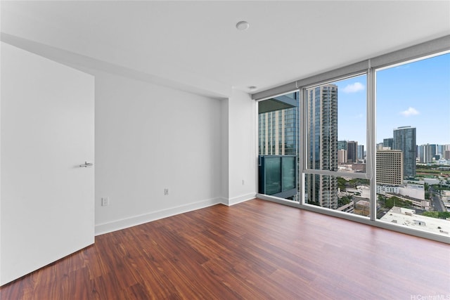 629 Keeaumoku St Unit 2408, Honolulu, HI 96814 - empty room featuring wood finished floors, expansive windows, and a view of city