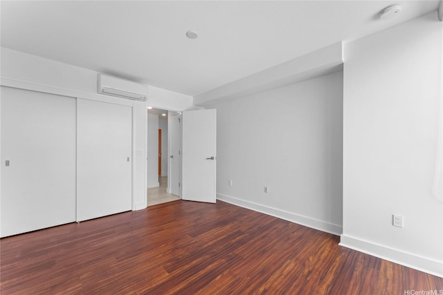 629 Keeaumoku St Unit 2408, Honolulu, HI 96814 - unfurnished bedroom featuring a wall unit AC, wood finished floors, and a closet