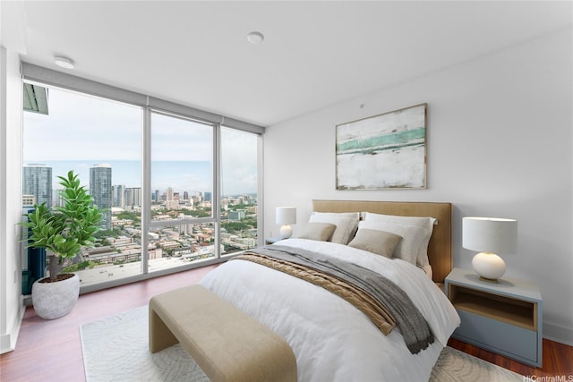 629 Keeaumoku St Unit 2408, Honolulu, HI 96814 - bedroom featuring a view of city, floor to ceiling windows, and wood finished floors