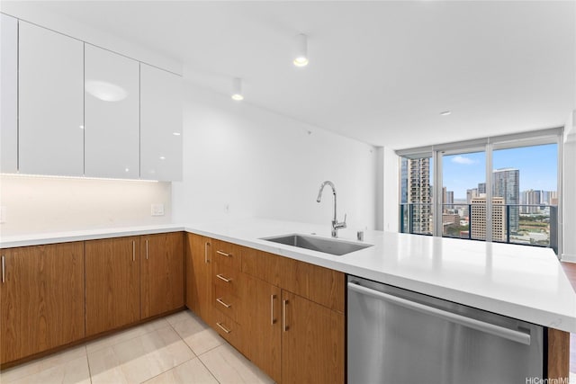 629 Keeaumoku St Unit 2408, Honolulu, HI 96814 - kitchen featuring dishwasher, light countertops, light tile patterned floors, brown cabinets, and a peninsula