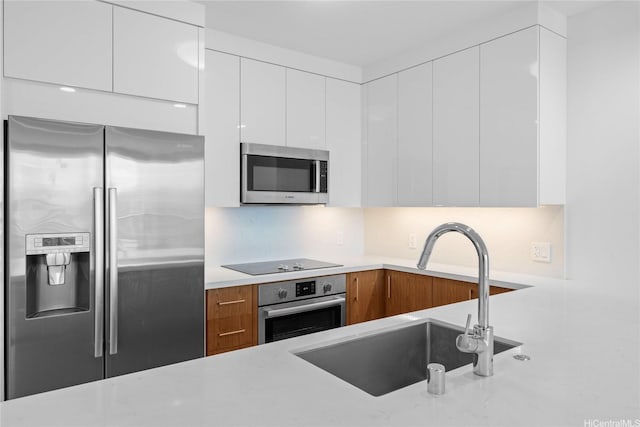 629 Keeaumoku St Unit 2408, Honolulu, HI 96814 - kitchen featuring stainless steel appliances, modern cabinets, light countertops, white cabinets, and brown cabinetry