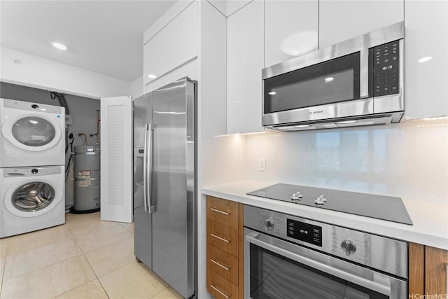 629 Keeaumoku St Unit 2408, Honolulu, HI 96814 - kitchen with stainless steel appliances, stacked washing machine and dryer, strapped water heater, and modern cabinets
