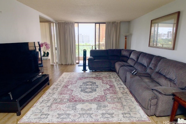 1860 Ala Moana Blvd Unit 910, Honolulu, HI 96815 - living room with light wood-type flooring, floor to ceiling windows, and a textured ceiling
