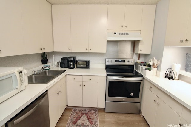 1860 Ala Moana Blvd Unit 910, Honolulu, HI 96815 - kitchen featuring premium range hood, stainless steel appliances, light wood-style floors, and light countertops