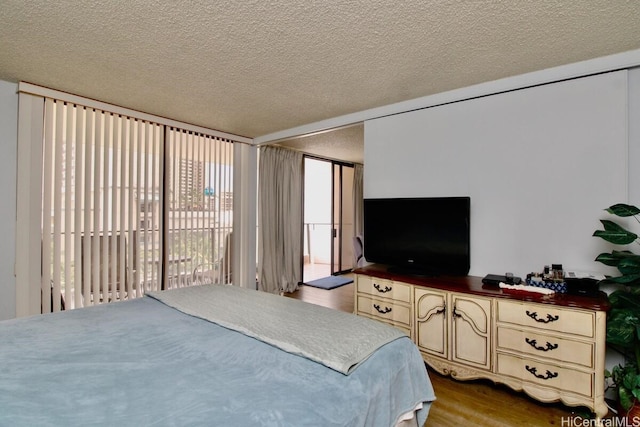 1860 Ala Moana Blvd Unit 910, Honolulu, HI 96815 - bedroom with access to outside, wood finished floors, and a textured ceiling