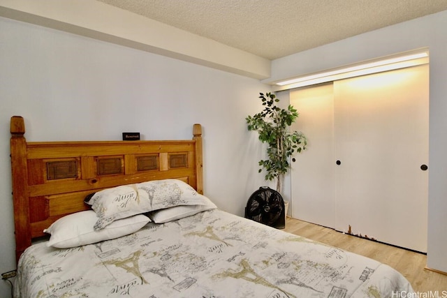 1860 Ala Moana Blvd Unit 910, Honolulu, HI 96815 - bedroom with light wood finished floors, a textured ceiling, and a closet