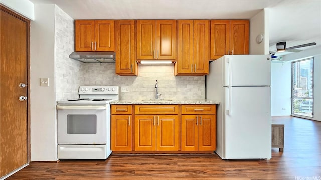 1655 Makaloa St Unit 903, Honolulu, HI 96814 - kitchen with white appliances, under cabinet range hood, brown cabinets, a ceiling fan, and backsplash