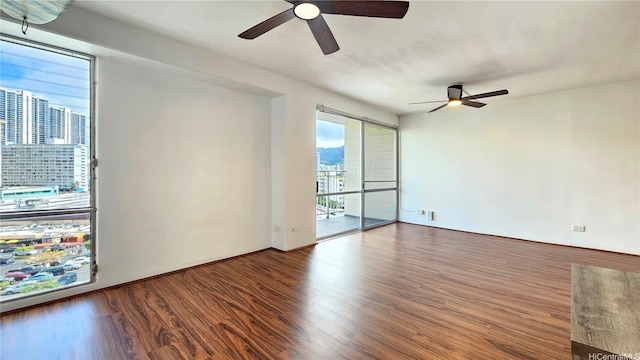 1655 Makaloa St Unit 903, Honolulu, HI 96814 - spare room with a ceiling fan, wood finished floors, and a view of city