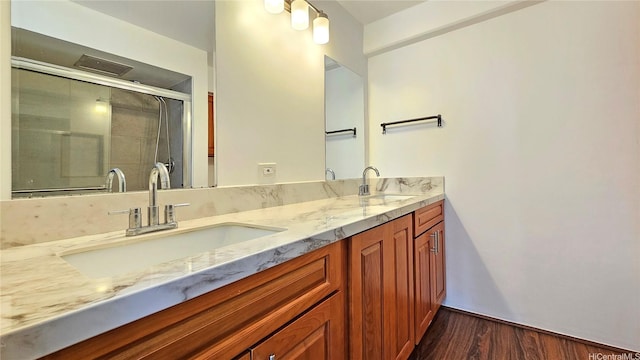 1655 Makaloa St Unit 903, Honolulu, HI 96814 - full bath featuring double vanity, wood finished floors, and a shower with shower door