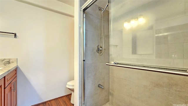 1655 Makaloa St Unit 903, Honolulu, HI 96814 - full bathroom featuring vanity, a stall shower, and wood finished floors