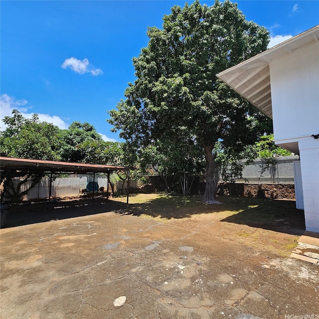 3216 Kaimuki Ave, Honolulu, HI 96816 - fenced backyard with driveway and a detached carport