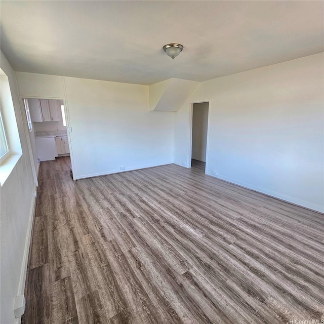 3216 Kaimuki Ave, Honolulu, HI 96816 - unfurnished living room with dark wood finished floors and baseboards