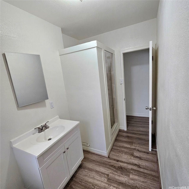 3216 Kaimuki Ave, Honolulu, HI 96816 - full bathroom featuring wood finished floors, vanity, and a stall shower