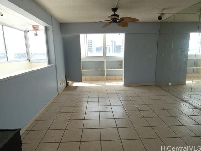 2421 Ala Wai Blvd Unit 1701, Honolulu, HI 96815 - empty room featuring ceiling fan, light tile patterned floors, and a textured ceiling