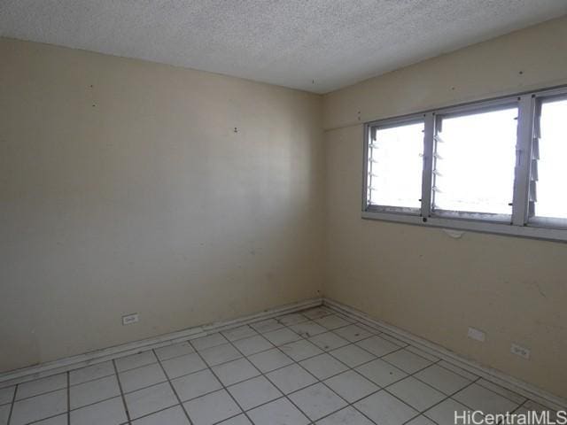 2421 Ala Wai Blvd Unit 1701, Honolulu, HI 96815 - empty room featuring a textured ceiling and baseboards