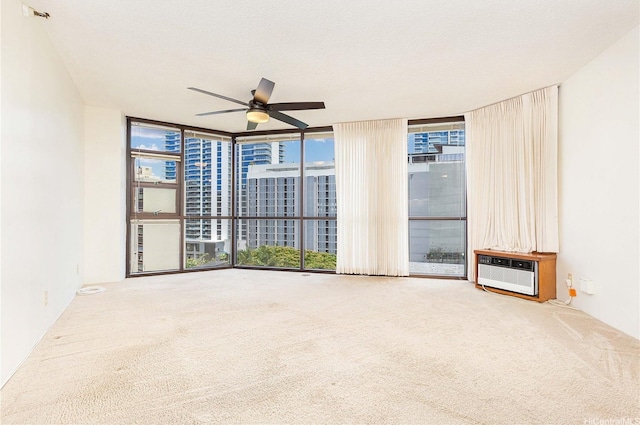 930 Kaheka St Unit 802, Honolulu, HI 96814 - carpeted empty room with expansive windows, a ceiling fan, and a wall mounted AC