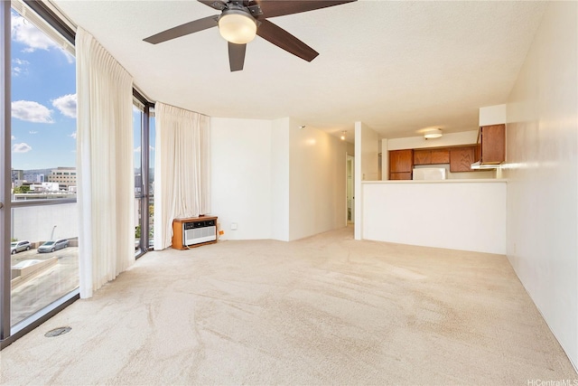 930 Kaheka St Unit 802, Honolulu, HI 96814 - unfurnished living room featuring light colored carpet, a ceiling fan, and a wall of windows