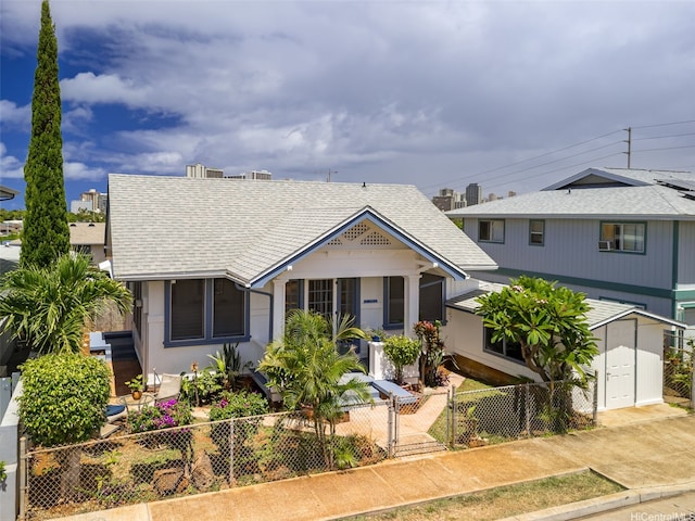 3413 Winam Ave, Honolulu, HI 96815 - view of front facade featuring a fenced front yard, a storage shed, and roof with shingles
