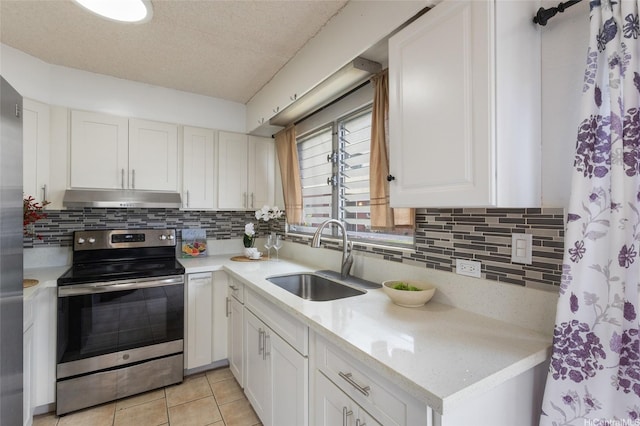 3225 Ala Ilima St Unit 2, Honolulu, HI 96818 - kitchen featuring stainless steel electric stove, under cabinet range hood, light countertops, decorative backsplash, and a textured ceiling