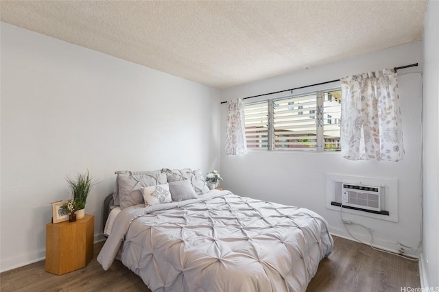 3225 Ala Ilima St Unit 2, Honolulu, HI 96818 - bedroom featuring wood finished floors, an AC wall unit, and a textured ceiling