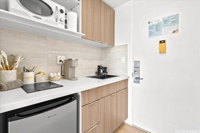 2427 Kuhio Ave Unit 1205, Honolulu, HI 96815 - kitchen featuring tasteful backsplash, light countertops, stainless steel dishwasher, modern cabinets, and light brown cabinetry