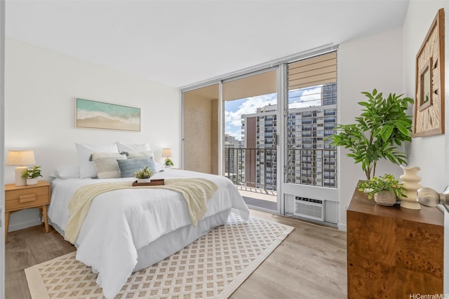 2345 Ala Wai Blvd Unit 1918, Honolulu, HI 96815 - bedroom featuring access to exterior, wood finished floors, a wall of windows, and a city view