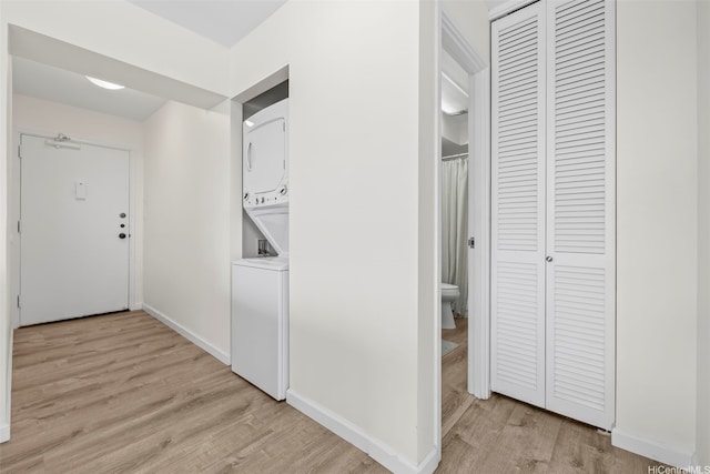 2345 Ala Wai Blvd Unit 1918, Honolulu, HI 96815 - hall featuring stacked washer and clothes dryer and light wood-style floors
