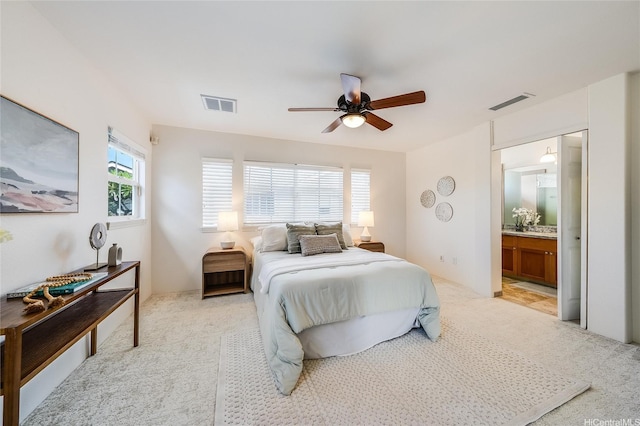580 Lunalilo Home Rd Unit 358, Honolulu, HI 96825 - bedroom with light colored carpet, connected bathroom, and ceiling fan