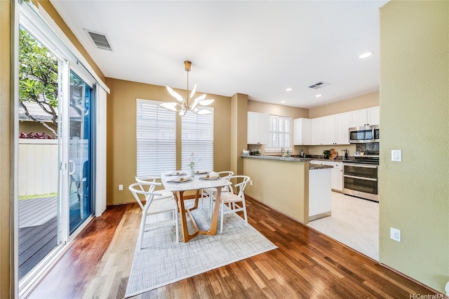 580 Lunalilo Home Rd Unit 358, Honolulu, HI 96825 - dining area featuring a chandelier, light wood-style flooring, and recessed lighting
