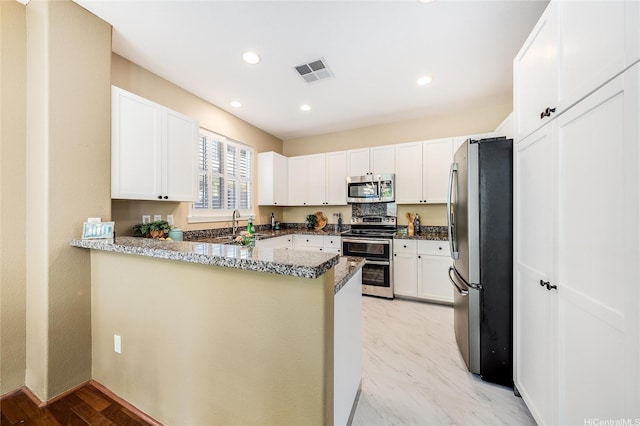 580 Lunalilo Home Rd Unit 358, Honolulu, HI 96825 - kitchen with stainless steel appliances, a peninsula, dark stone counters, white cabinetry, and recessed lighting
