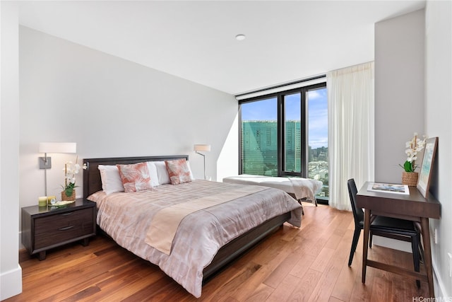 1108 Auahi St Unit 2906, Honolulu, HI 96814 - bedroom featuring hardwood / wood-style flooring and floor to ceiling windows