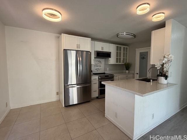 94-586 Lumiauau St Unit N104, Waipahu, HI 96797 - kitchen featuring appliances with stainless steel finishes, glass insert cabinets, a peninsula, light countertops, and white cabinets