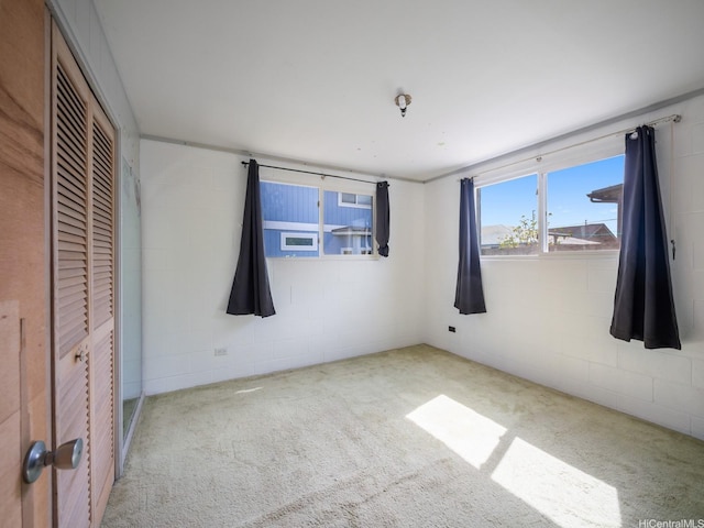1114 8th Ave, Honolulu, HI 96816 - unfurnished bedroom with carpet, concrete block wall, and a closet