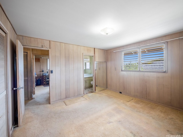 1114 8th Ave, Honolulu, HI 96816 - unfurnished bedroom featuring light carpet, wood walls, and connected bathroom
