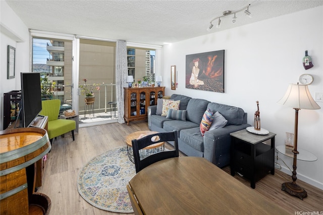 2115 Ala Wai Blvd Unit 1003, Honolulu, HI 96815 - living room with wood finished floors, plenty of natural light, and a textured ceiling