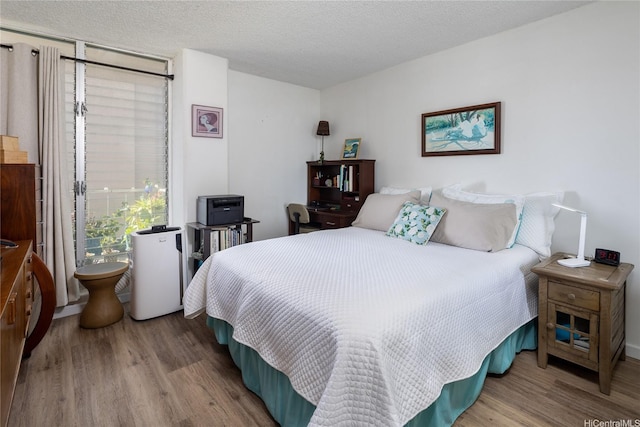 2115 Ala Wai Blvd Unit 1003, Honolulu, HI 96815 - bedroom featuring wood finished floors and a textured ceiling