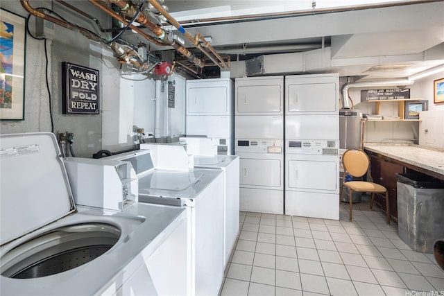 2115 Ala Wai Blvd Unit 1003, Honolulu, HI 96815 - communal laundry room featuring stacked washing machine and dryer, light tile patterned floors, and washing machine and clothes dryer