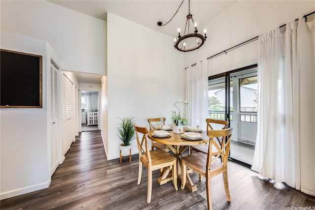 95-150 Kuahelani Ave Unit 255, Mililani, HI 96789 - dining area featuring a chandelier, dark wood-style floors, and a towering ceiling