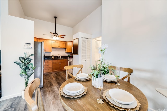 95-150 Kuahelani Ave Unit 255, Mililani, HI 96789 - dining space featuring high vaulted ceiling, dark wood-style flooring, and ceiling fan