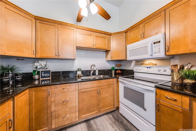 95-150 Kuahelani Ave Unit 255, Mililani, HI 96789 - kitchen featuring white appliances, wood finished floors, a ceiling fan, and dark stone counters